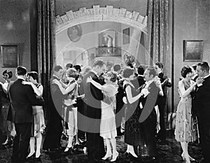 Group of people dancing in a ballroom photo