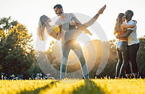 Group of people dancing Kizomba in sunset