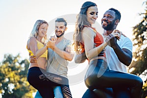 Group of people dancing Kizomba in sunset