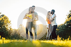 Group of people dancing Kizomba in sunset