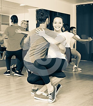 Group of people dancing salsa in studio