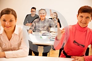 Group of people of different age sitting in classroom and attend