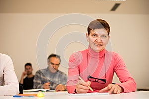 Group of people of different age sitting in classroom and attend