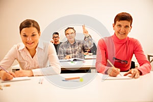 Group of people of different age sitting in classroom and attend