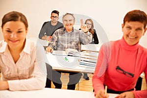 Group of people of different age sitting in classroom and attend