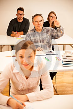 Group of people of different age sitting in classroom and attend