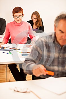 Group of people of different age sitting in classroom and attend