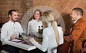 Group of people dining out merrily in country restaurant