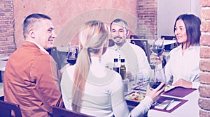 Group of people dining out merrily in country restaurant