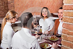 Group of people dining out merrily in country restaurant