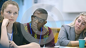 Group of people in diverse audience attend seminar irrl. Colleagues on lecture listen to information