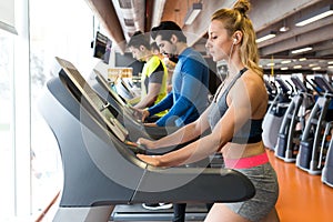 Group of people doing cardio training in gym.