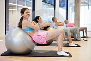 Group of people doing crunches on swiss balls