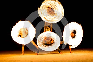 Group of people doing Fire show on beach party