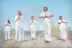 Group of People Doing Yoga on Beach