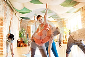 group of people doing yoga exercises at studio