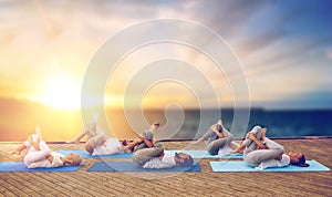 Group of people doing yoga pose outdoors