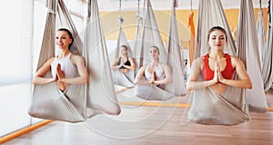 Group of people engaged in a class of yoga Aero in hammocks antigravity