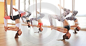 Group of people engaged in a class of yoga Aero in hammocks antigravity