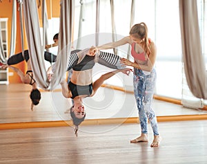 Group of people engaged in a class of yoga Aero in hammocks antigravity