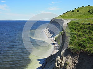 Group of people engaged in garbage collection along the rocky coast contaminated with plastic waste saving flora and fauna