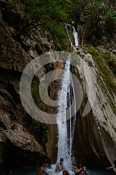 Group of people enjoying under the famous neer garh Waterfall, Rishikesh, Uttarakhand India