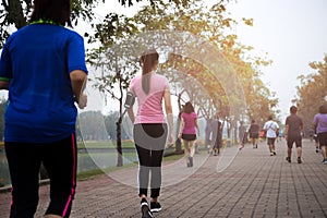 Group of people exercise walking in the park