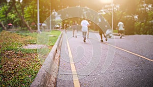 Group of people exercise walking and running in the park.