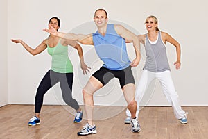 Group Of People Exercising In Dance Studio