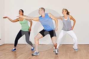 Group Of People Exercising In Dance Studio