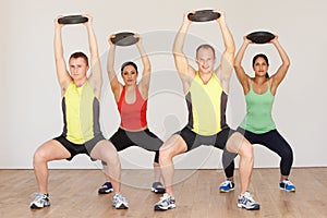 Group Of People Exercising In Dance Studio With Weights