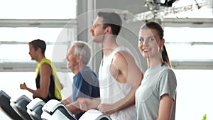 Group of people exercising at gym.