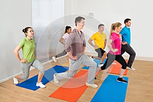 Group Of People Exercising On Mat