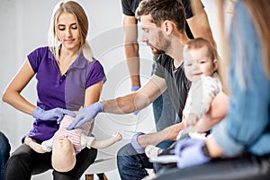 Group of people during the first aid training for baby