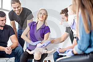 Group of people during the first aid training for baby