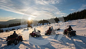 Group of people on four-wheelers ATV bikes, enjoying beautiful sunset in the the mountains in winter