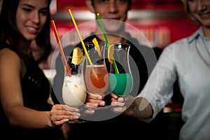 Group of people gathering in cocktail bar and having fun