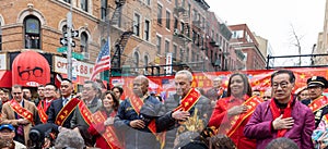 Group of people gathering together and holding hands over the heart during the parade