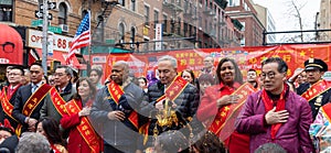 Group of people gathering together and holding hands over the heart during the parade