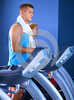 Group of people at the gym exercising on cross