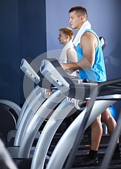 Group of people at the gym exercising on cross