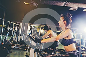 Group of people in the gym exercising legs doing cardio training