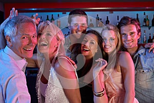 Group Of People Having Fun In Busy Bar