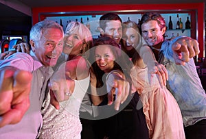 Group Of People Having Fun In Busy Bar