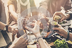 Group of people having meal togetherness dining toasting glasses