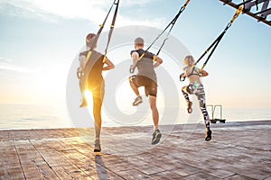 Group of people having Trx training