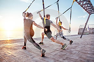 Group of people having Trx training