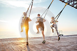 Group of people having Trx training