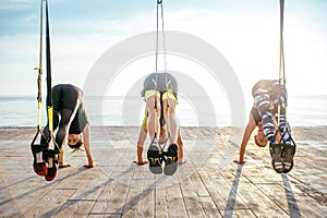 Group of people having Trx training