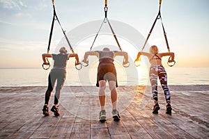 Group of people having Trx training